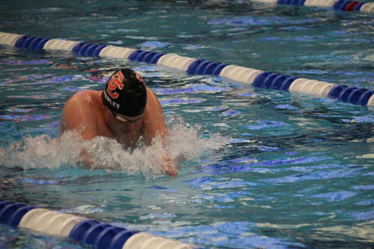 Sophomore George Crowley takes a stroke racing the competitors in the lanes beside him. 