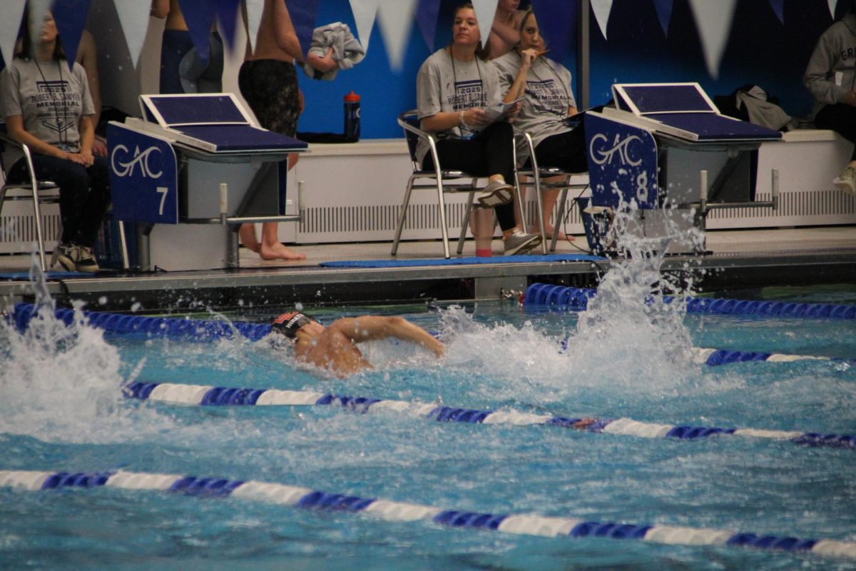 Junior Zach Hirata takes a breath, making his way to the wall during his 200 freestyle.
