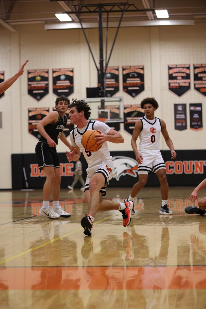 Rushing to the hoop, Senior Gavin Reese dribbles the ball, ready to face the defense.