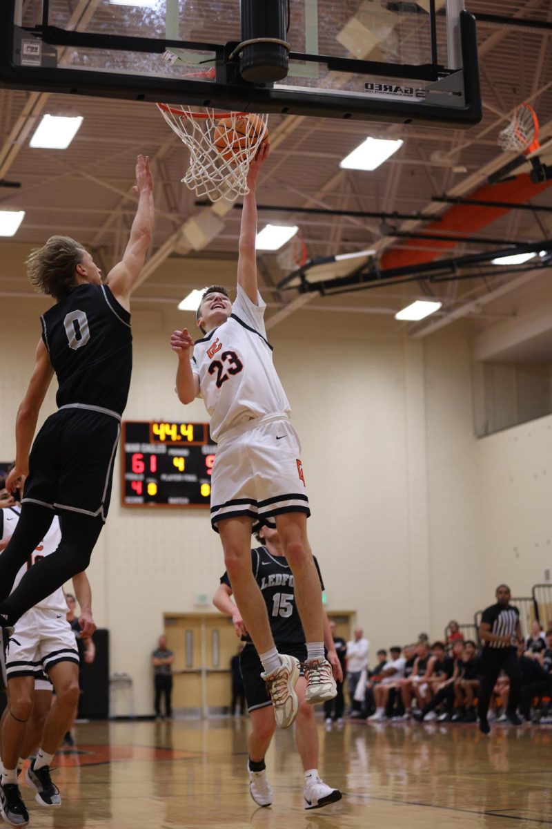 Nearing the victorious win for the War Eagles, Freshman Nolan Allen makes his jump towards the hoop to secure the win.