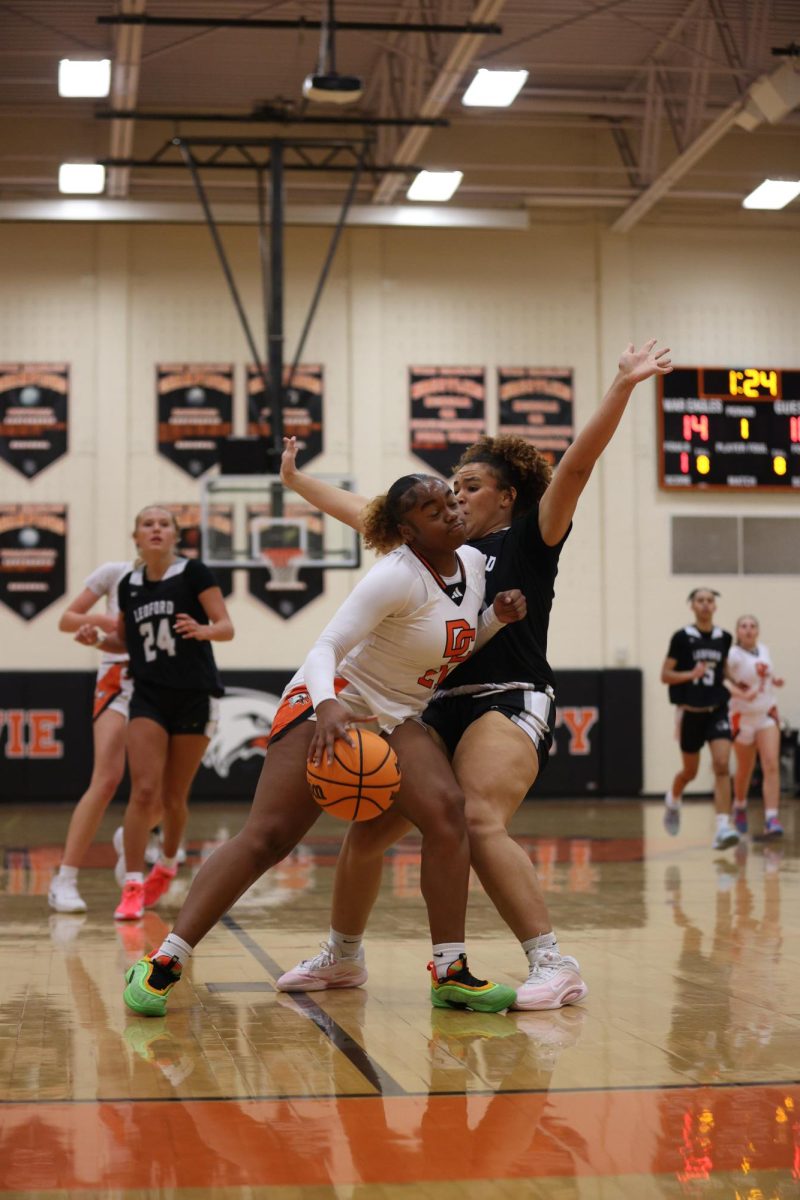 Aiming to get near the goal, Junior Londyn McDowell drives the Panthers defensive player away while getting ready to make the basket.