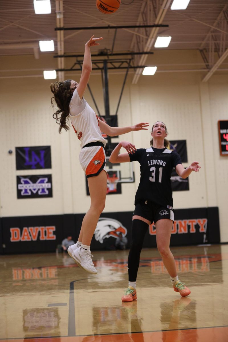 After Junior Emmie Burris passes the ball to assist Sophomore Olivia Smith, Smith shoots the ball and adds 2 points to the scoreboard.