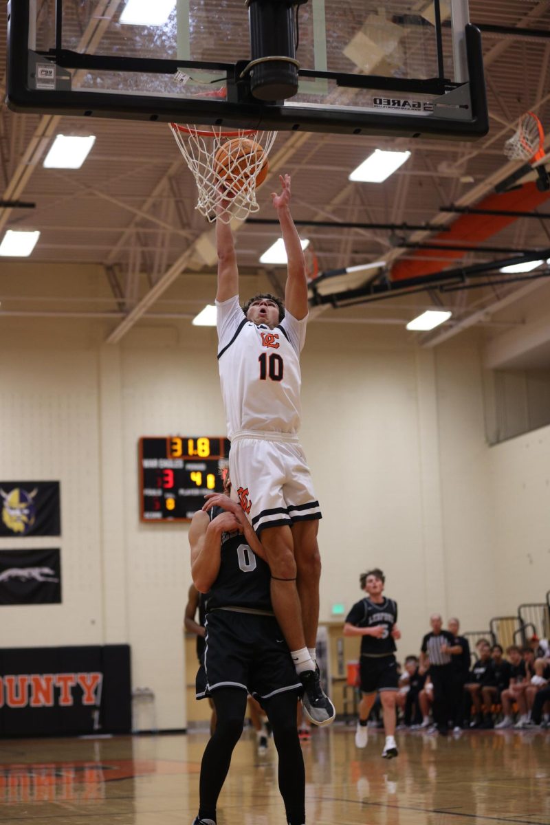 Before the referee blew the whistle, Sophomore William Martin jumps above the defense and makes the shot.