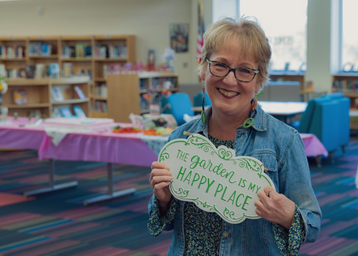 DHS English teacher Donna Dunn poses with a gift given to her at her retirement celebration held in the Davie High Learning Commons on Friday, January 16.