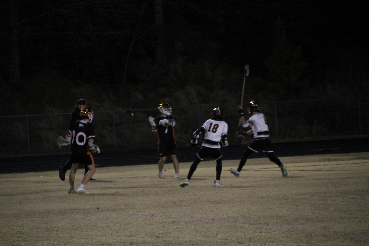 Sophomore Henry Hines scans the field to locate the pass to get someone open for a goal. 