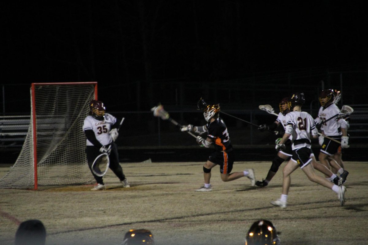 Senior Cas Moore makes a shot towards the goal after winning the face off and gaining possession. 