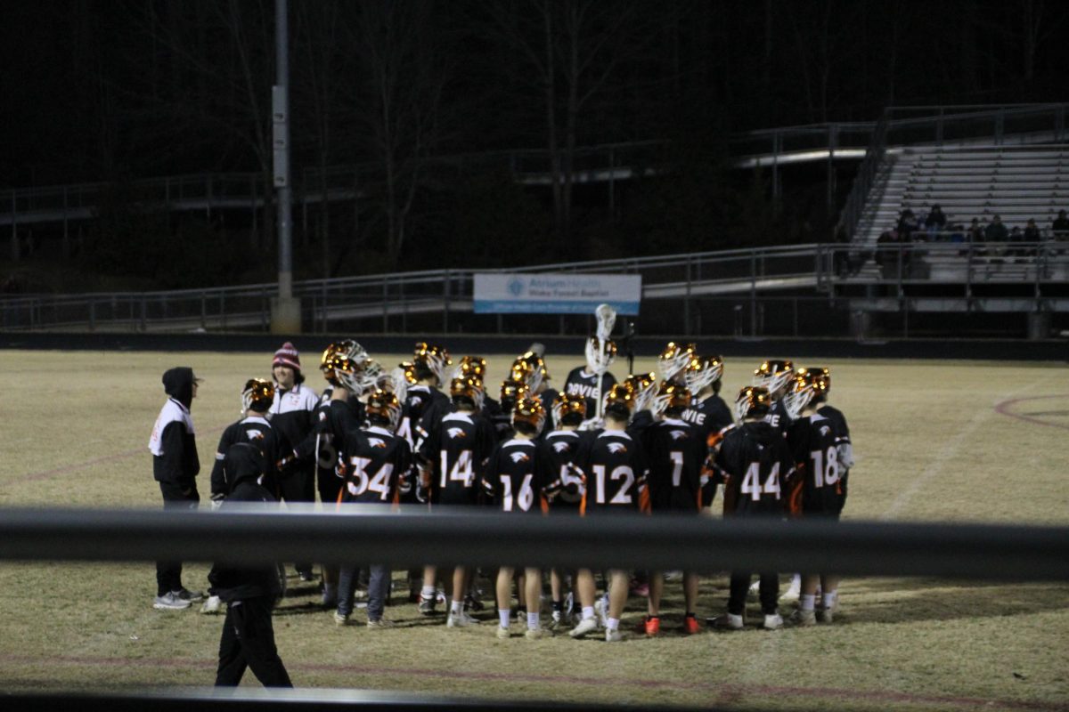 The team huddles during the first quarter break to discuss how to keep the momentum going throughout the rest of the game. 
