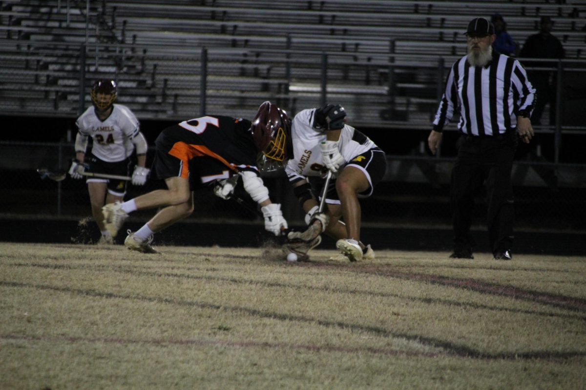 Reid Tilley fights during the face off to win possession and get the ball for Davie. 
