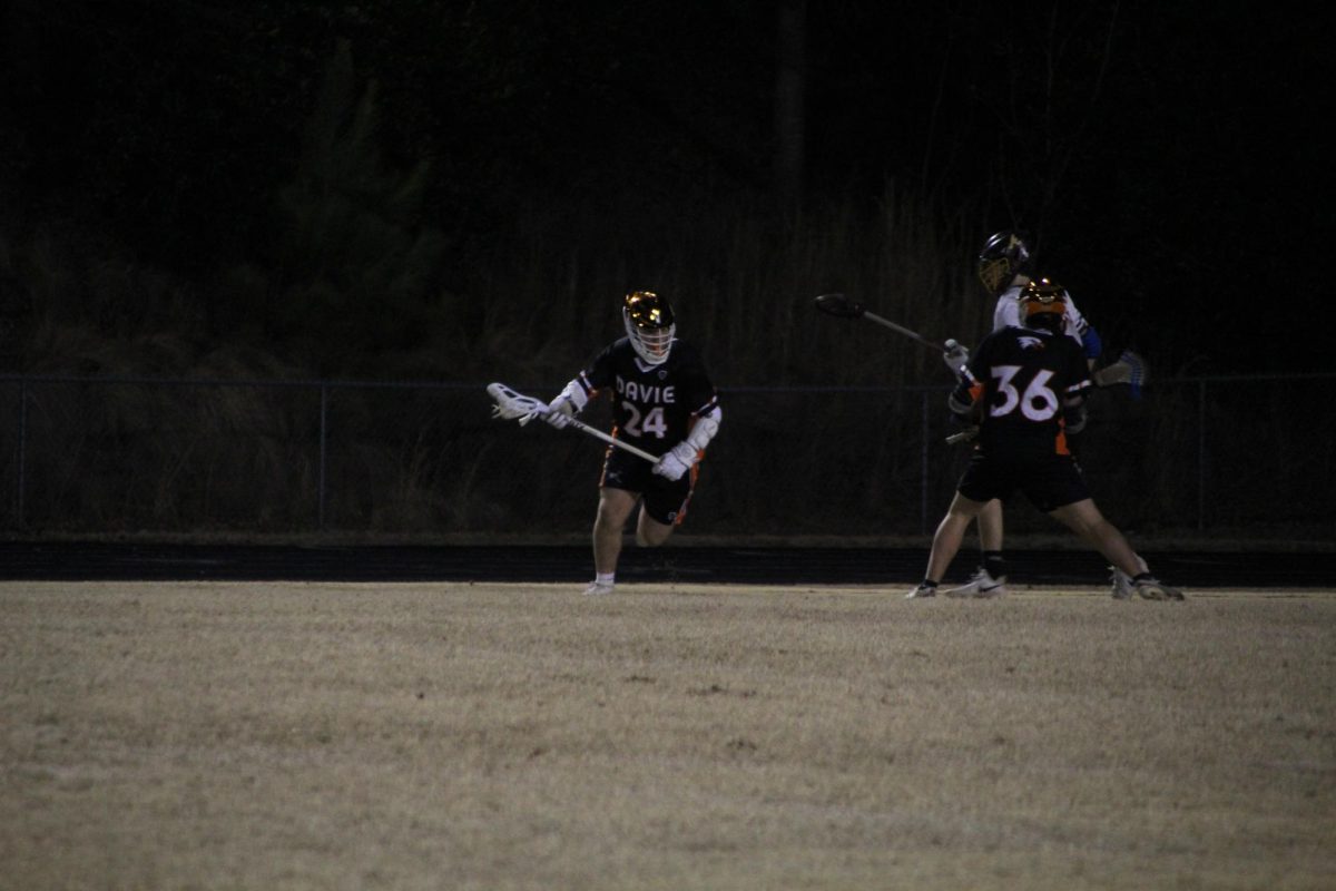 Dylan Casssetta makes a drive around his defenders trying to get through the opening and make a shot. 