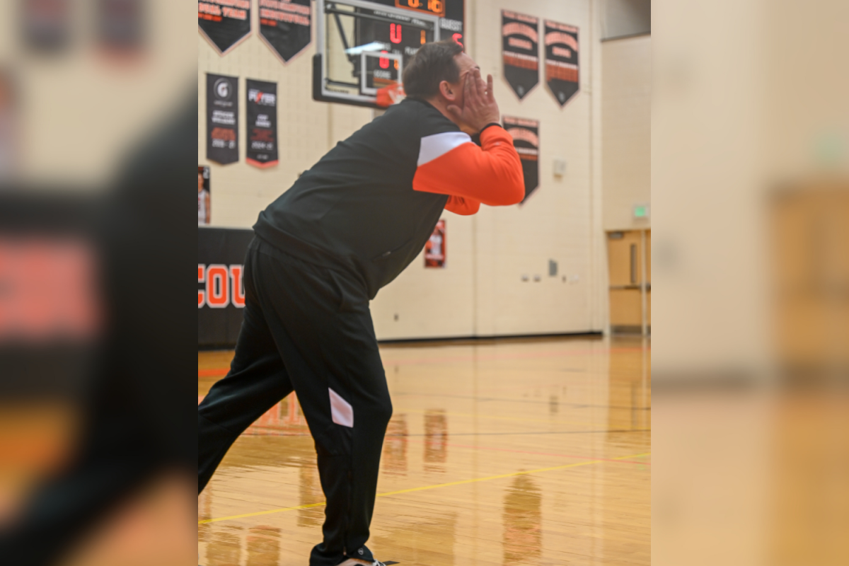 Women's basketball coach Jeremy Autry calls out to a player during a home match up.