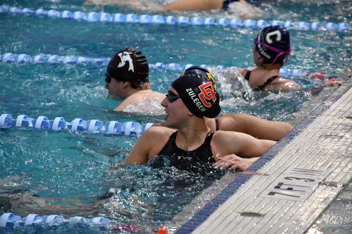 Sophomore Skylar Zuleger waits on the wall watching the clock during warmups. 