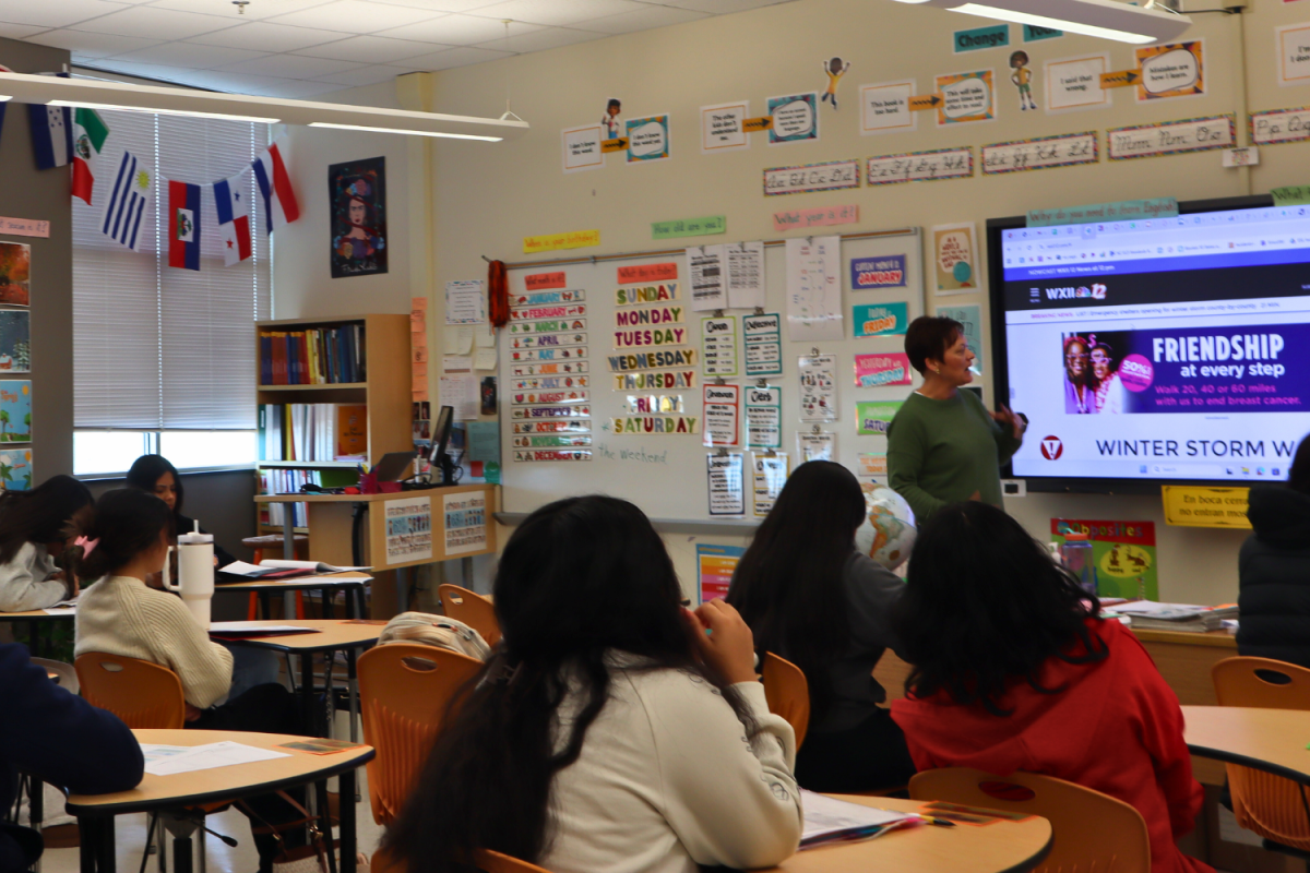 ESL teacher Susan Marion speaks to her students about the upcoming winter storm.
