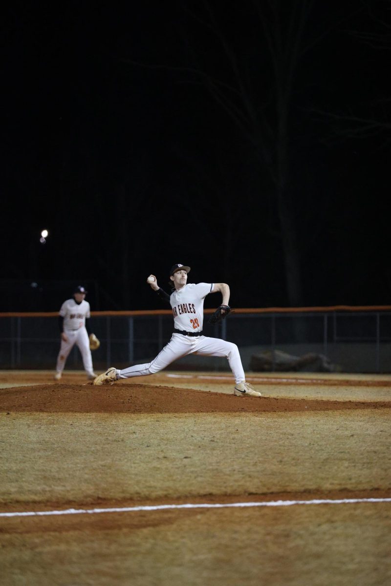 Junior Colin Harrison prepares to make the pitch, attempting to strike out the batter.