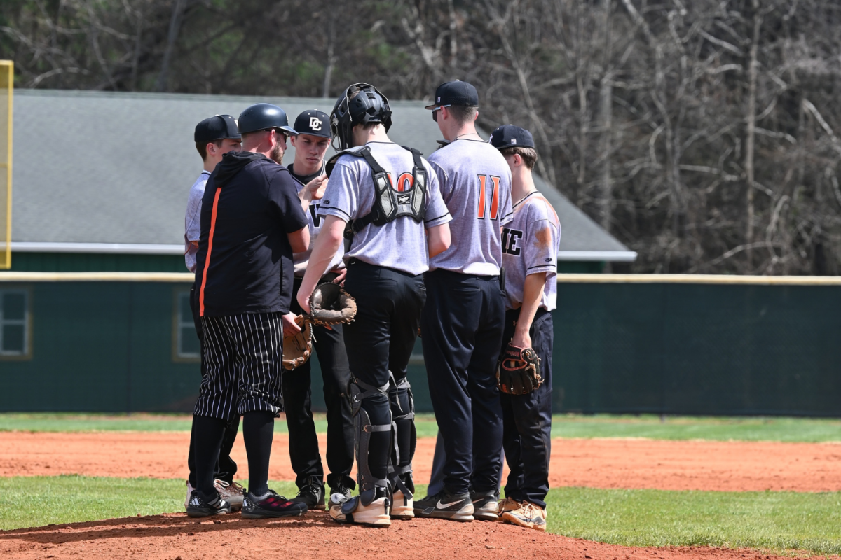 The teams huddles to make their gameplan for the rest of the inning. 
