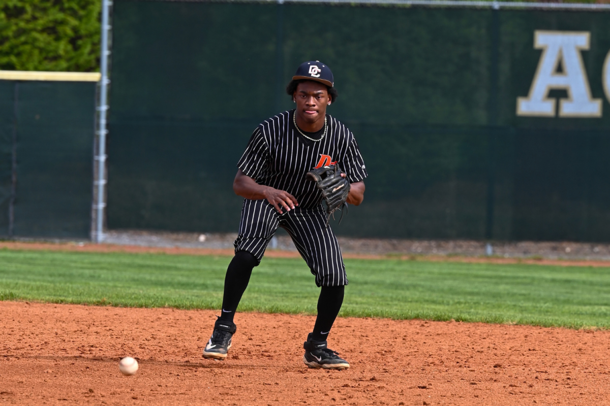 Brandon Forrest tracks the ball to field it and throw it to first base. 