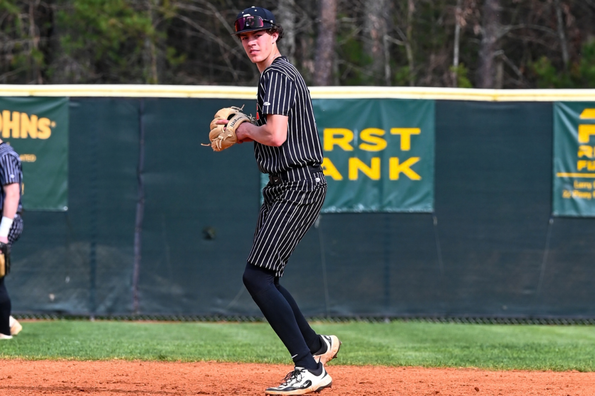 Hayden Potts gets ready to throw the ball to first base to make an out.