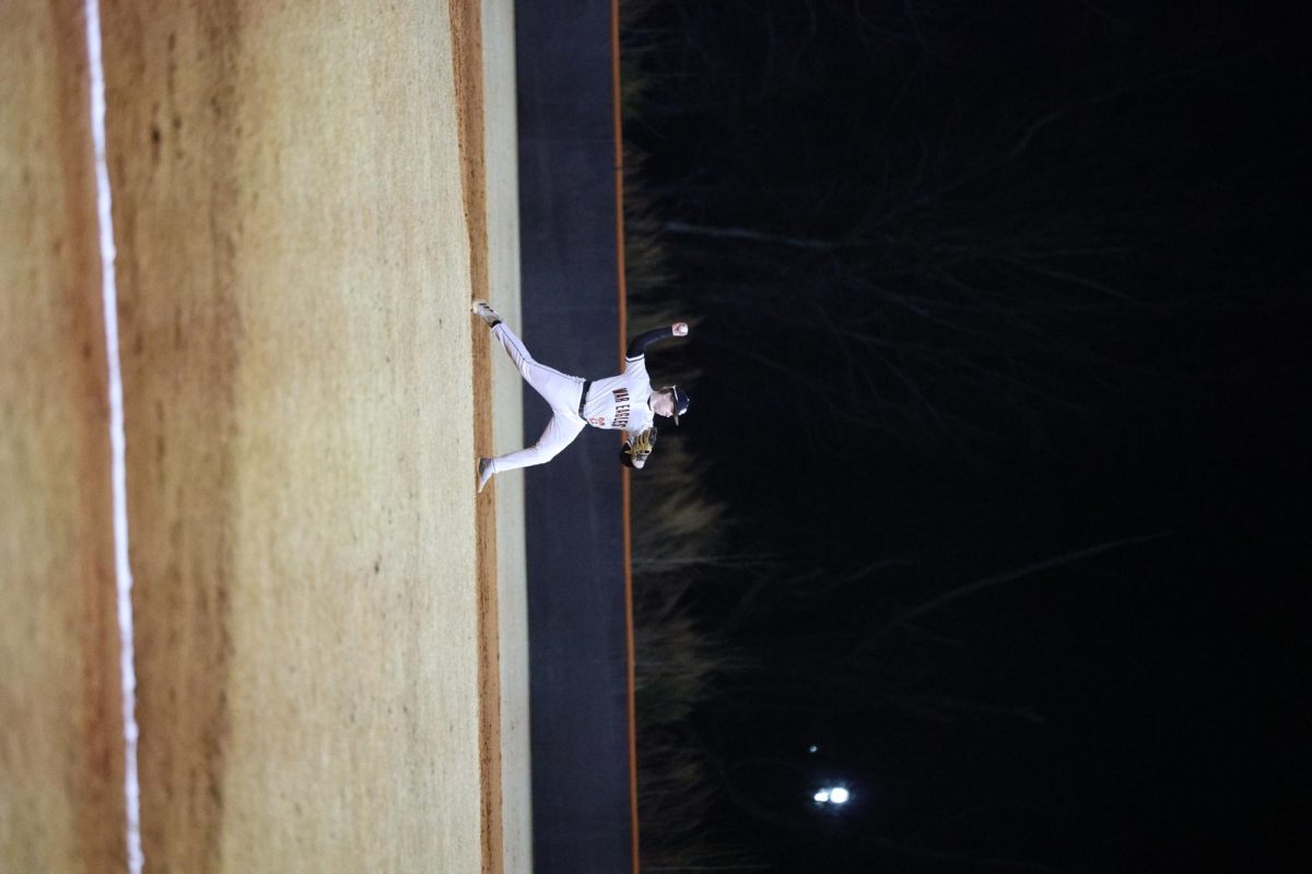 Senior Logan Allen makes eye contact with his teammate as he readies to make the pass to get the opposing team out. 