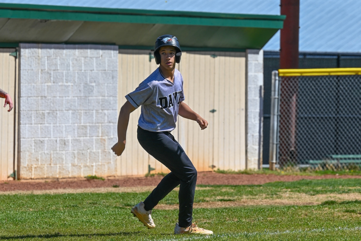 Preston Young looks down to home plate to see if he will be able to run and score.