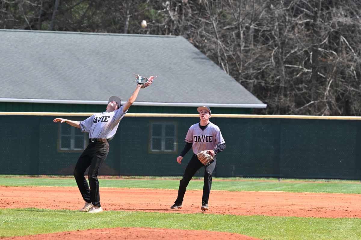 Paxton Brodus catches an infield pop fly with his brother, Peirson Brodus, behind him, ready to back him up.
