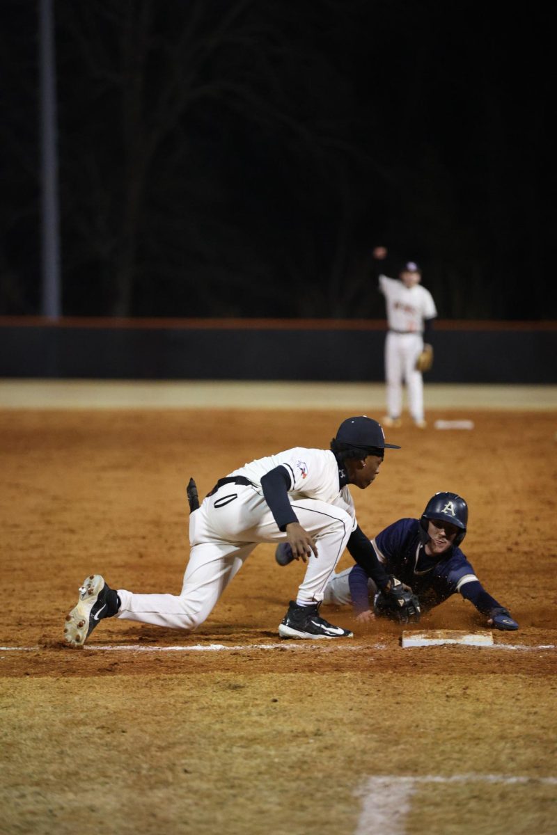 Sophomore Brandon Forest connects his glove with the opponent before they can make it too third base. 