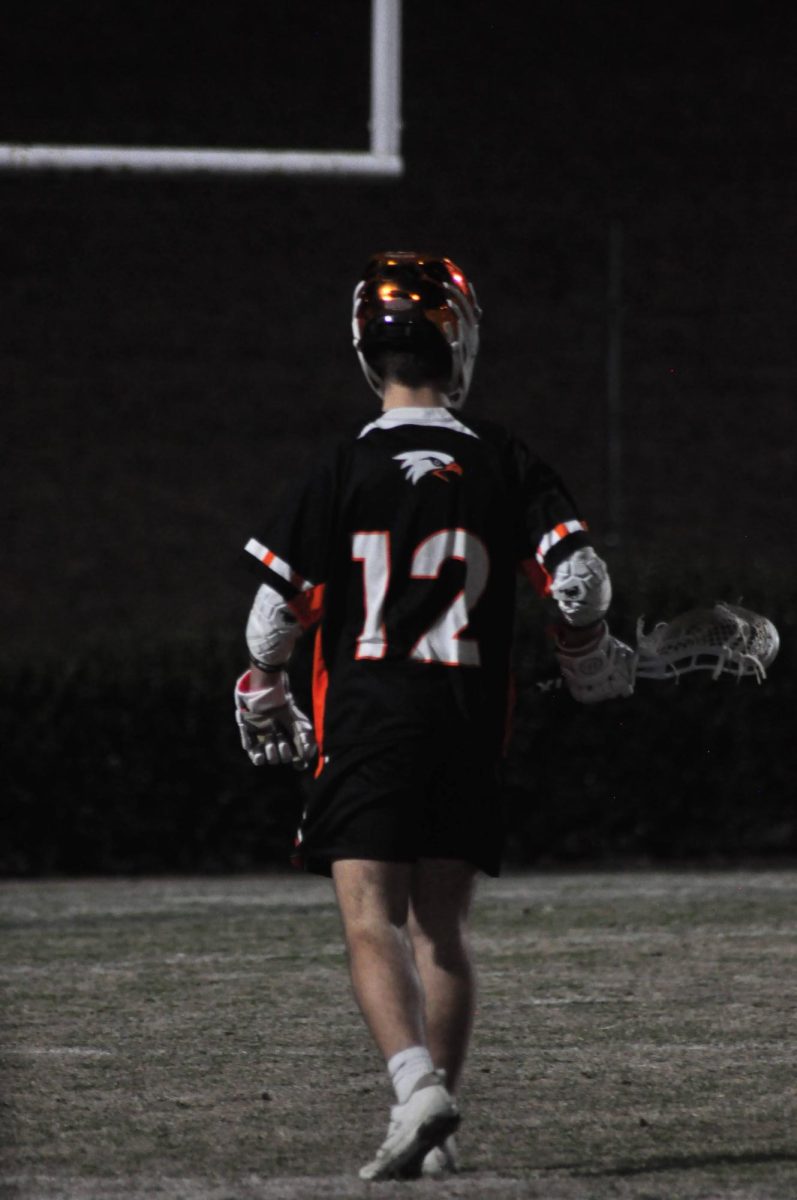 Junior Will Carter scans the field to see if there is a cut he can make to catch the ball and score. 