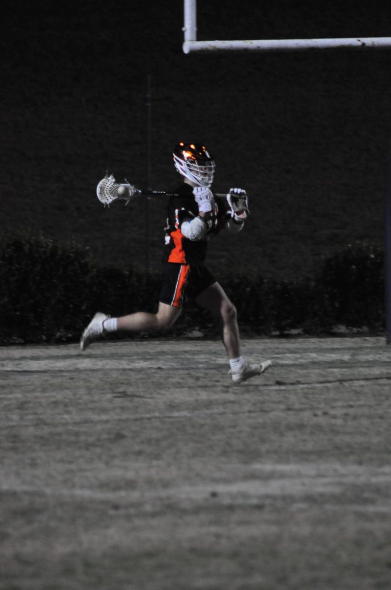 Junior Will Carter makes the midfield transition, getting the ball into the box so the team can play a successful offense. 