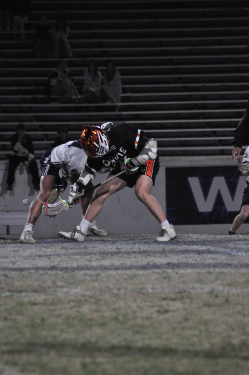Junior Reid Tilley fights against his opponent to pick up the ball during a faceoff. 