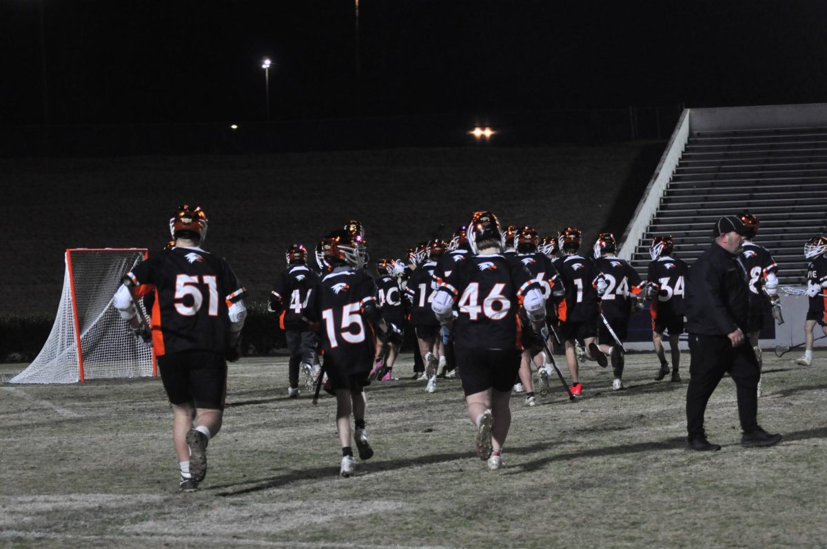 After emerging victorious, the team runs to their goalie to celebrate the win. 
