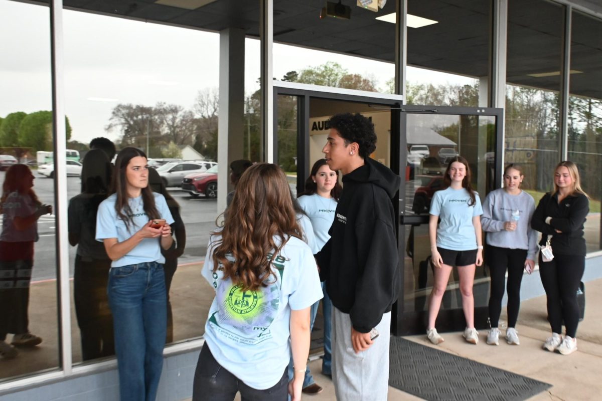 Kellan Wiles talks to Hannah Ehst, the Davie FCA leader, before he walks into the event. 