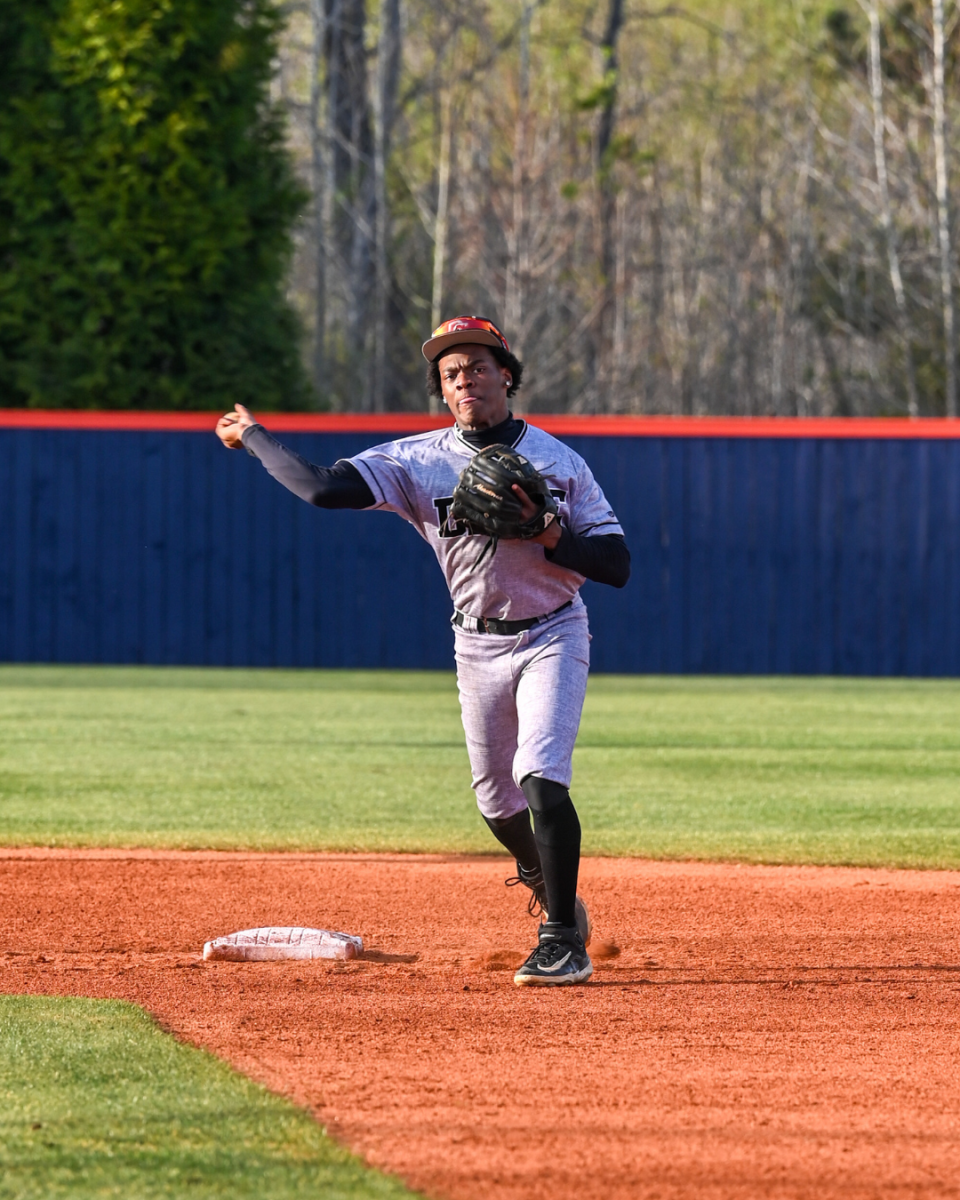 Brandon Forrest throws the ball to first base for an out.