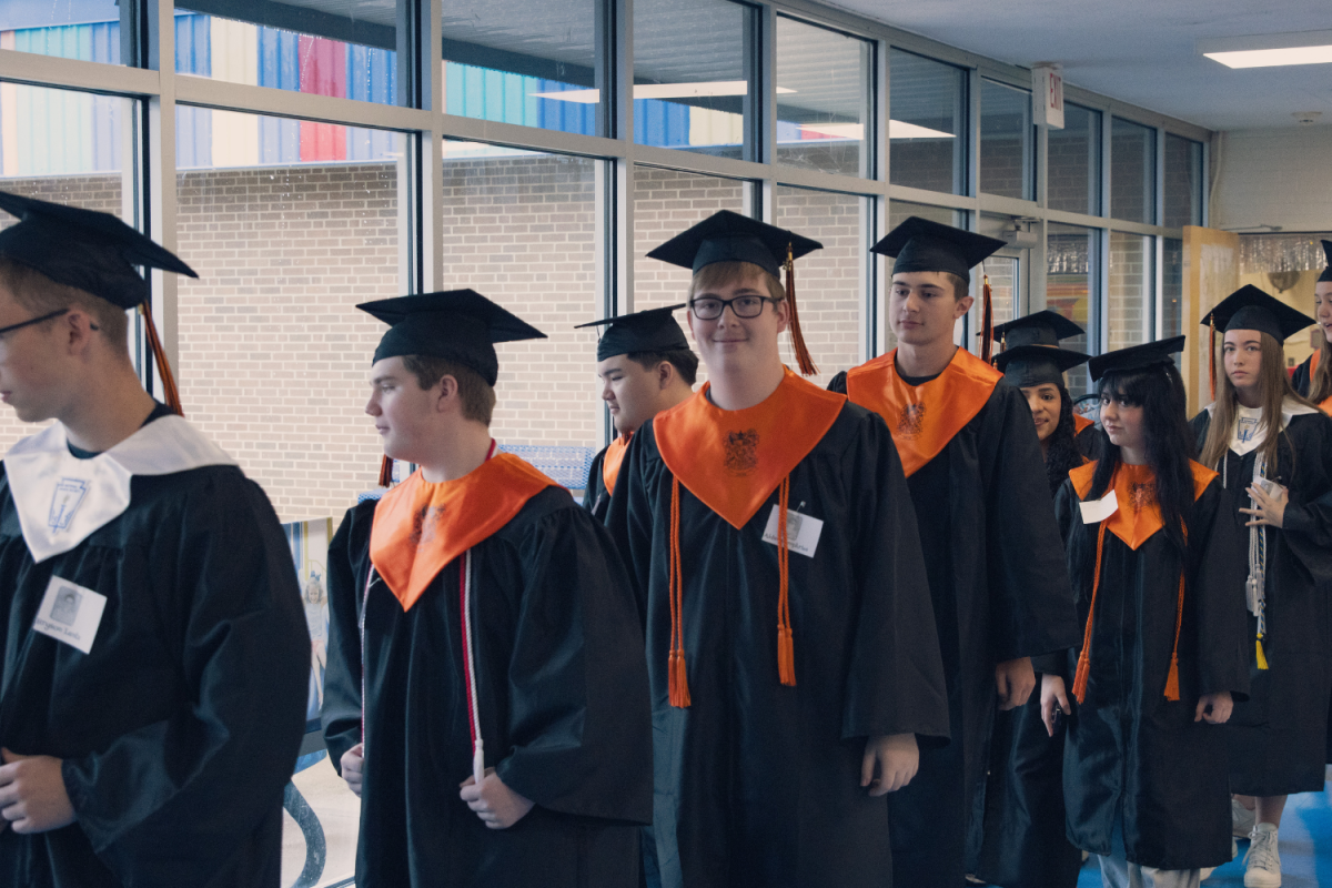 Davie High seniors line up in the halls of Mocksville Elementary on Senior Day 2026. It is tradition for DHS seniors to return to their elementary school to walk the halls in their caps and gowns one last time.