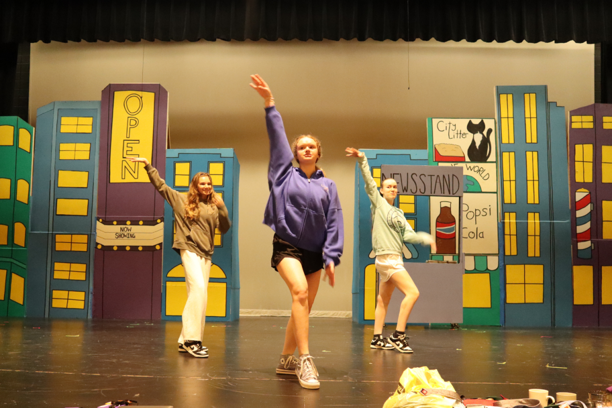Senior Raegan Kreul models her choreography for two dancers during a rehearsal for "Guys and Dolls."