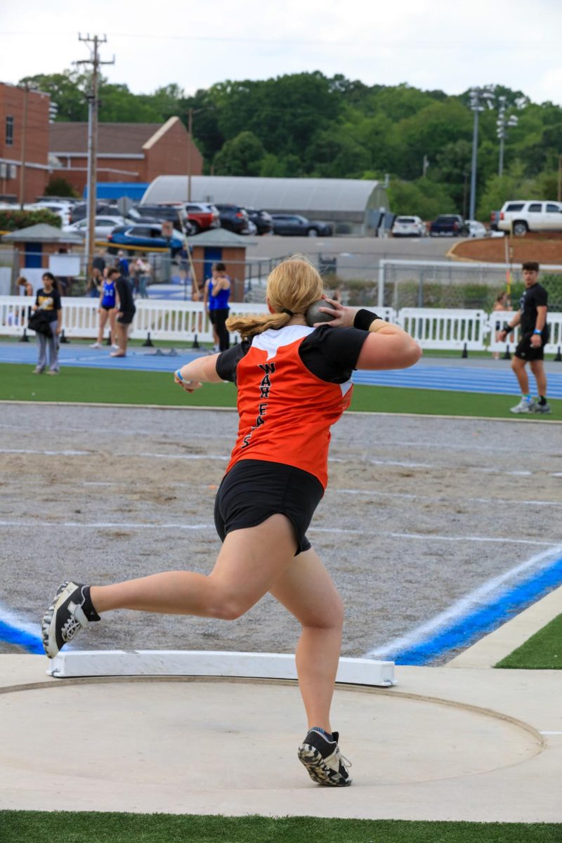 Layla Hazlip spins around to launch the shot put into the air.