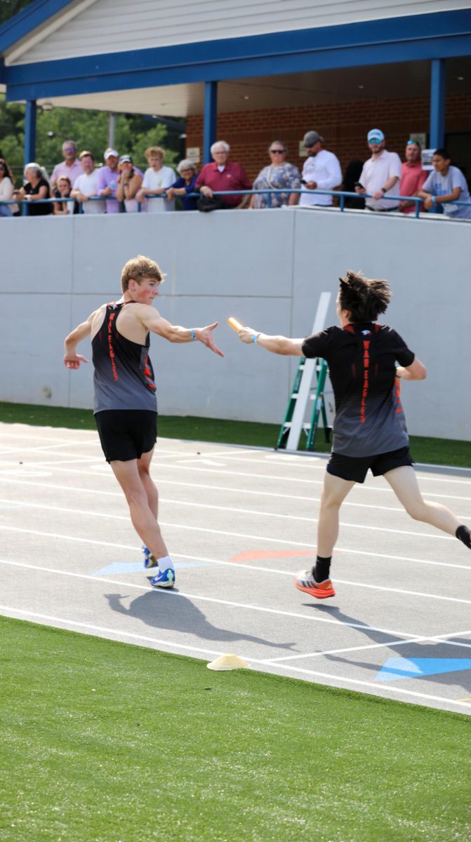 Jonah Prevette hands off the baton to Patrick Brady in the 4x8