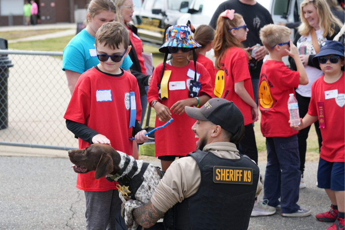 Shady Grove's Charlie admired Briar, a Davie County K-9 Dog, and finally worked up the nerve to pet her. This act of bravery earned him a honorary deputy badge. 