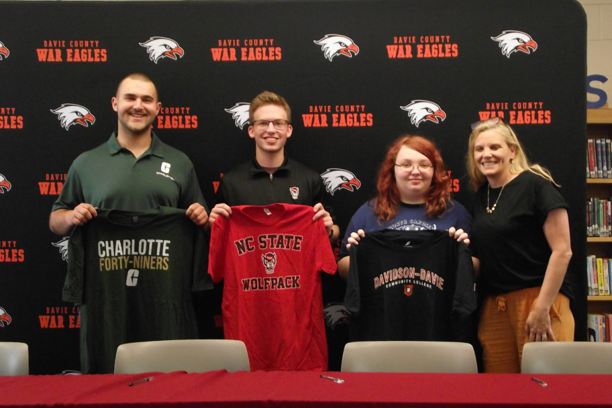 (Left to Right) Seniors Jackson Barrett, Bryson Lantz, and Meghan Clapper pose with Davie High principal Cindy Stone after participating in the second annual SkillsUSA signing day.