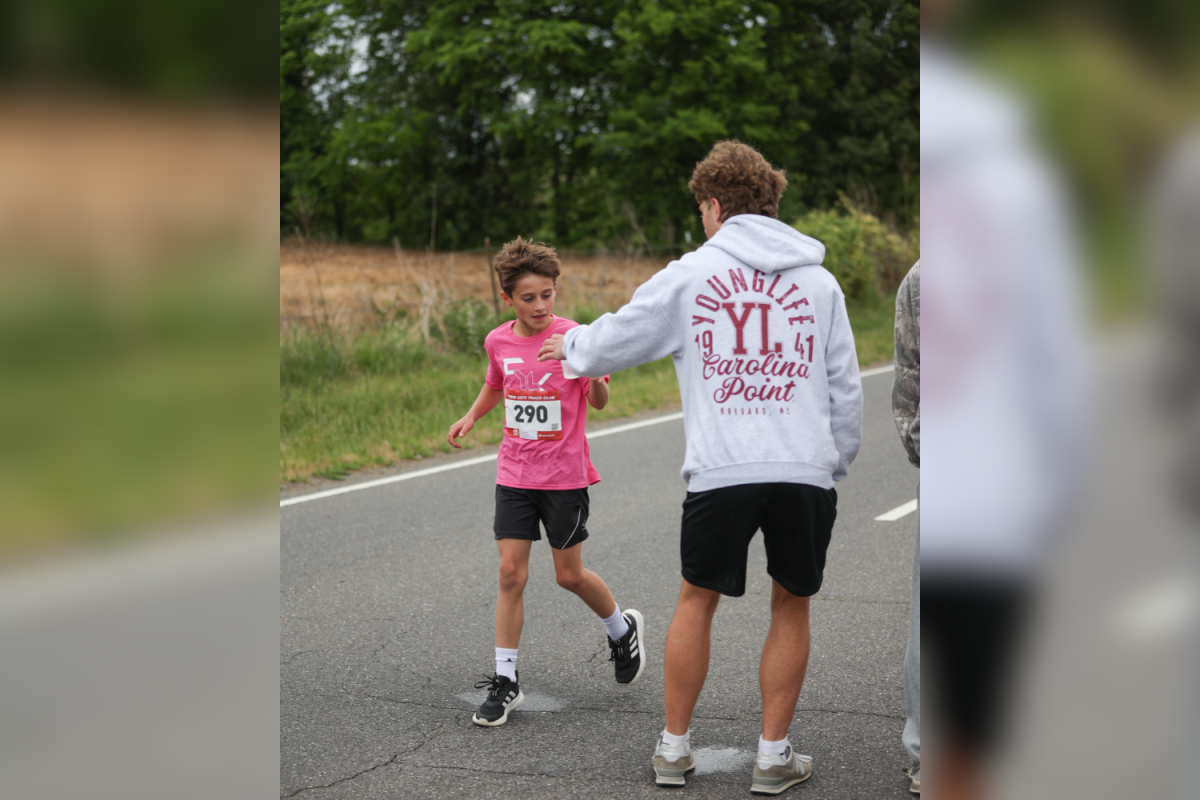 Standing at the ready on the course, senior Young Life leader Colson Sink makes it his mission to successfully hand out as many waters to the runners while shouting encouragement as they pass.
