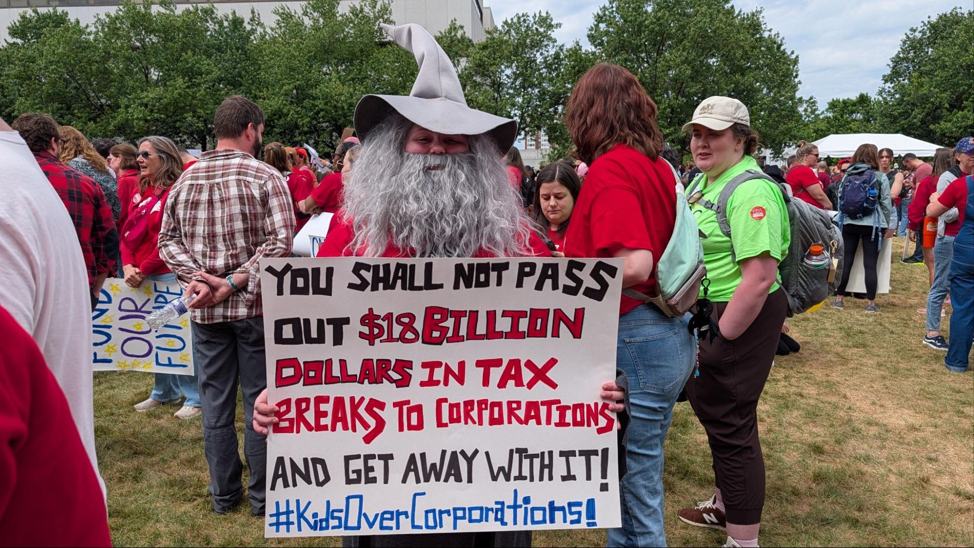 A teacher dressed as Gandalf the Grey from "The Lord of the Rings" carries a sign parodying a famous line from the character. | Photo courtesy Matt Barker