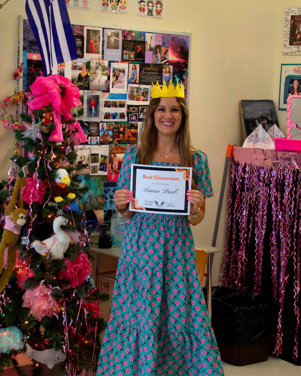 Laura Doub poses in her room to show off her Student Choice Award.