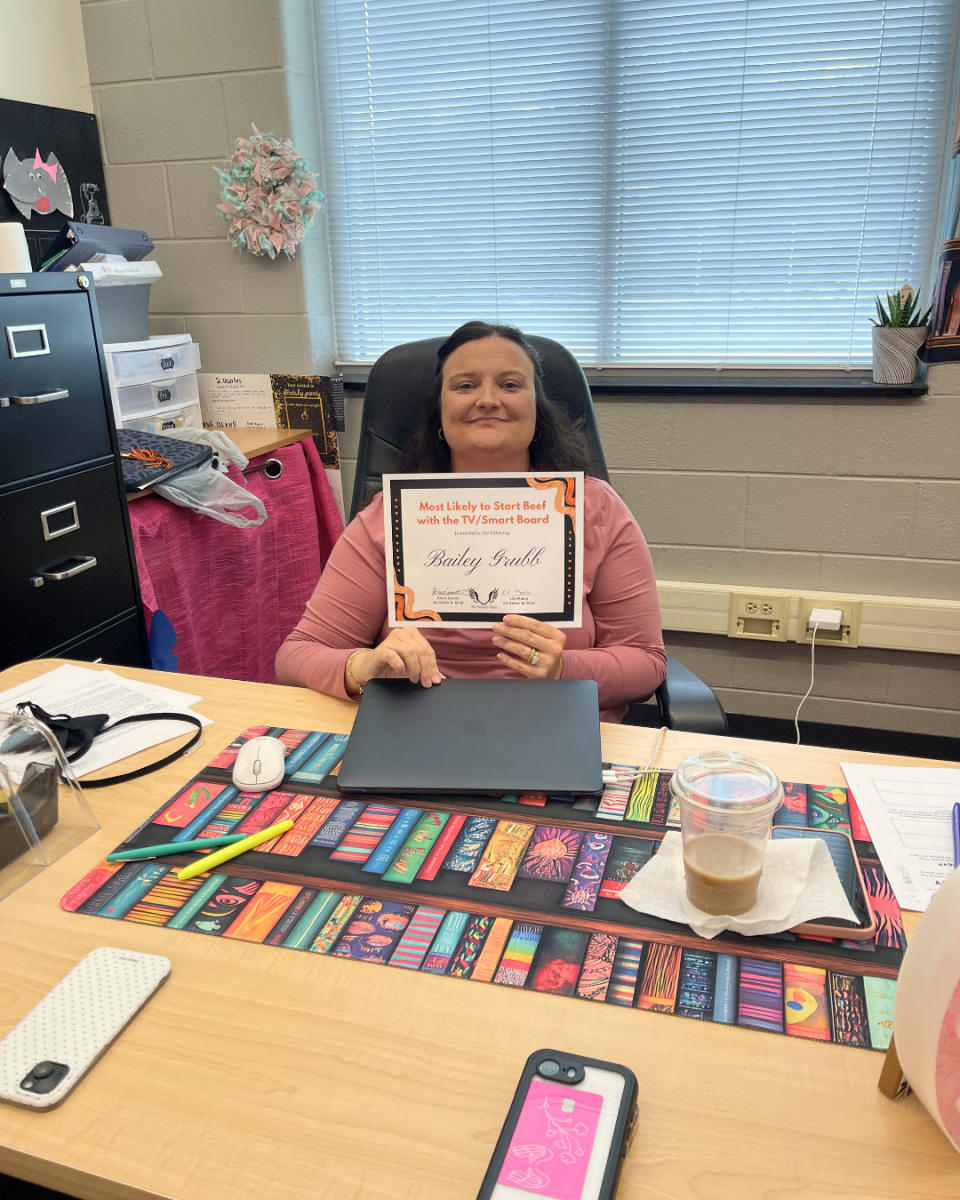 Bailey Grubb sits behind her desk (and far away from the TV) as she shows off her Student Choice Award