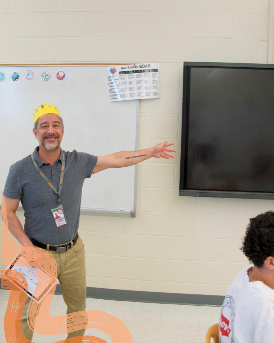 James Lovato gestures to a blank screen, exemplifying the trait that earned him his Student Choice Award.
