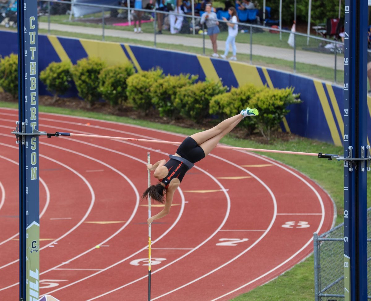 Senior Clara Phelps vaults over the pole in one of the final meets of the outdoor track post season. Phelps would go on to win the state championship in this event.